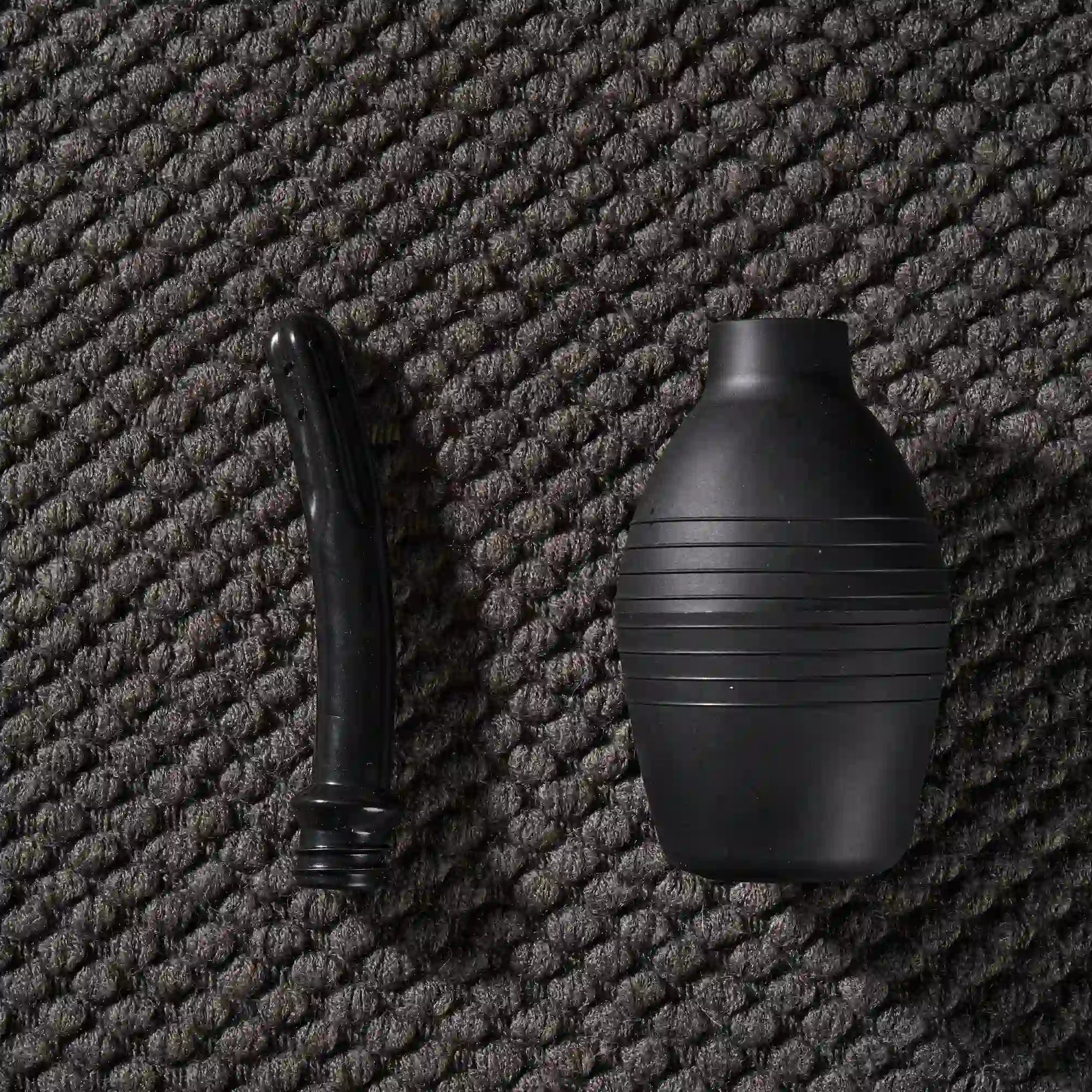 Image of Flat lay of manual silicone doll cleaning system components including water tank and hose with threaded connection