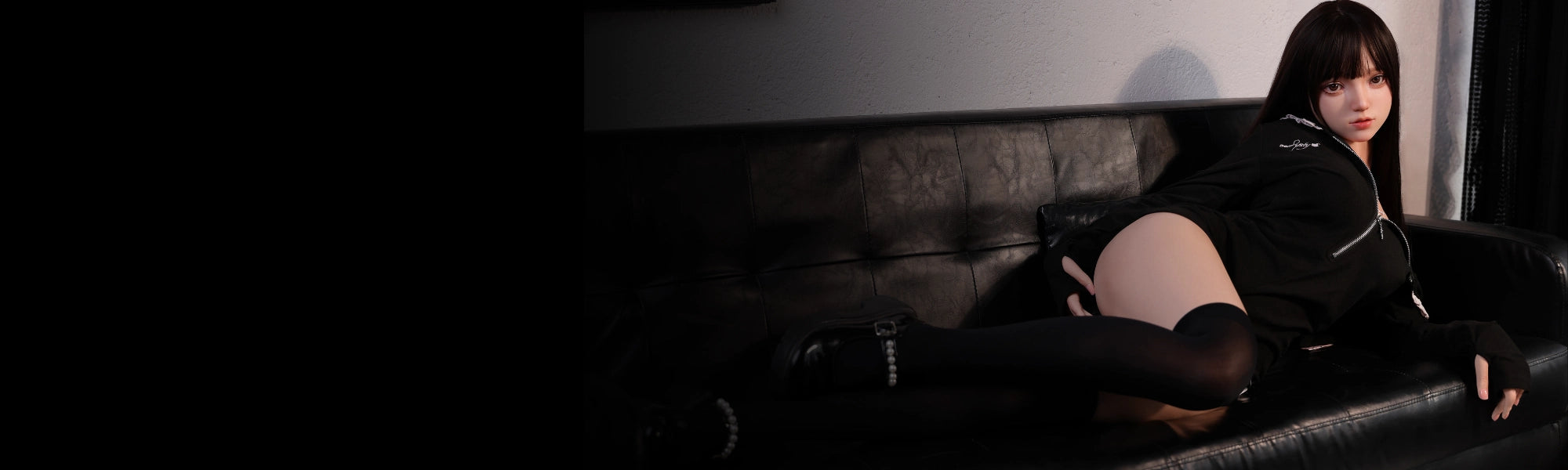 MRLDOLL Akane anime sex doll lying on a sofa with legs bent playfully, showcasing her cute Japanese-style figure