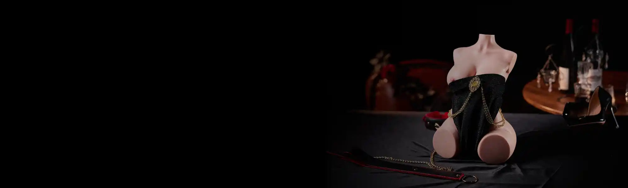 MRLDOLL KIKI mini silicone torso wearing black sparkling outfit with gold chains, positioned on the right side of the image, left side black space for text or banners