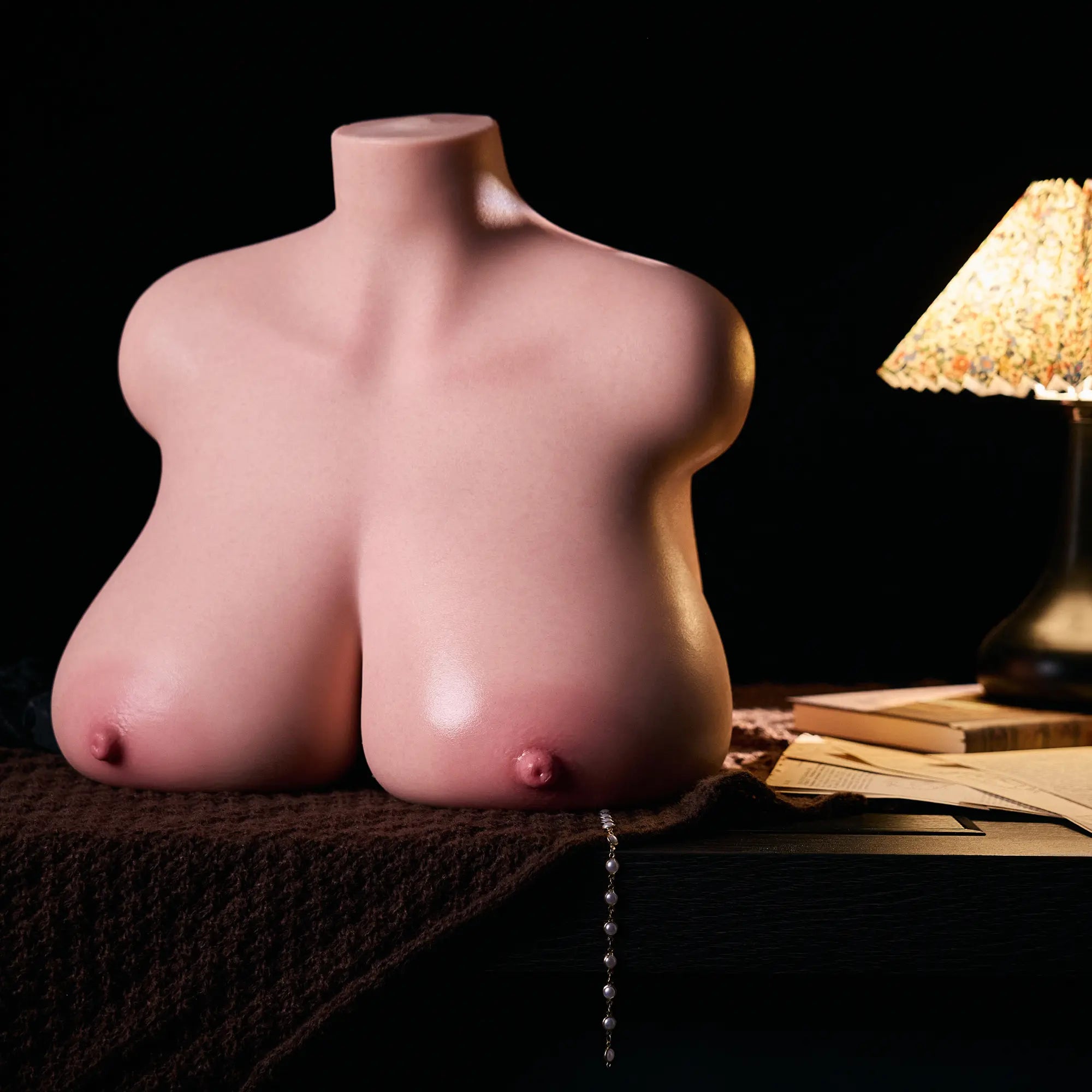 Image of MRLDOLL Tess torso placed on a desk, highlighting natural body curves and glossy, lifelike skin texture